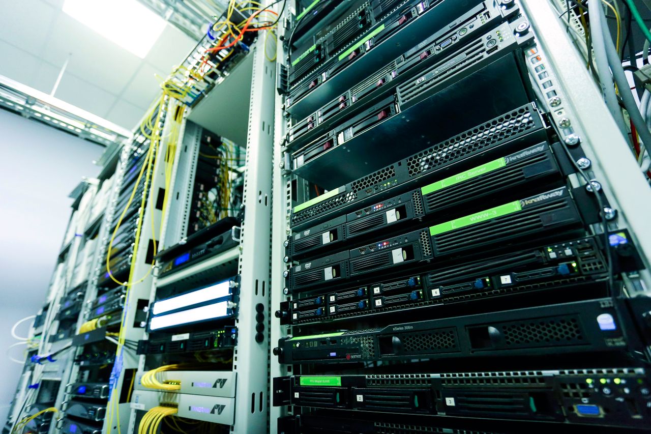 creative-02 High-tech server rack in a secure data center with network cables and hardware components.